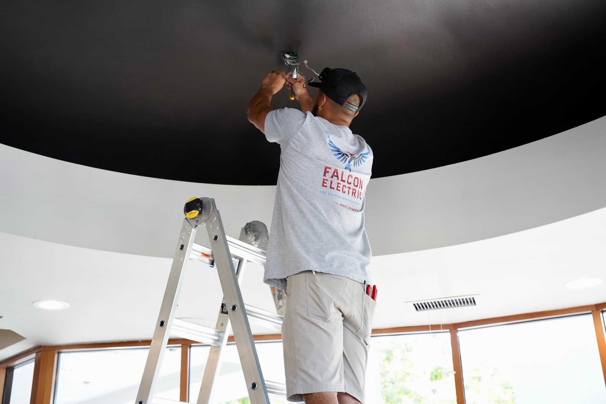 Ean Orchard installing a pendant fixture in a vaulted ceiling